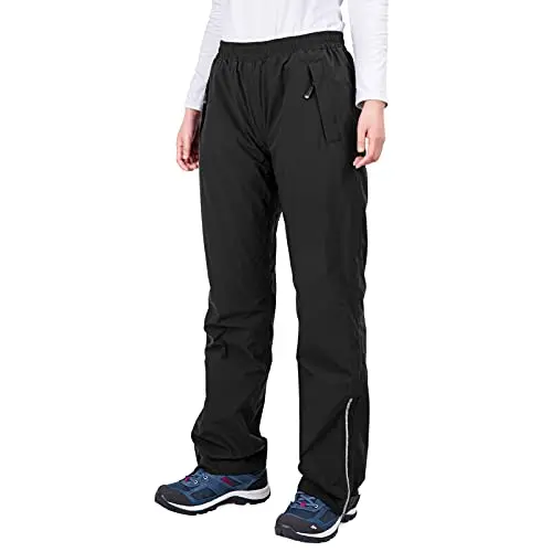 33,000ft women's black rain over pants with half-leg zips and reflective piping, worn over other pants.